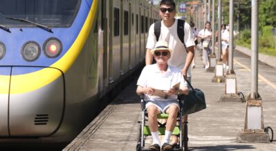 man-in-a-wheelchair-and-his-attendant-waiting-the-train-on-the-plaform