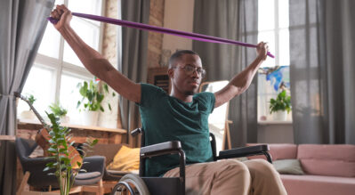 A-man-in-wheelchair-stretching-his-upper-body