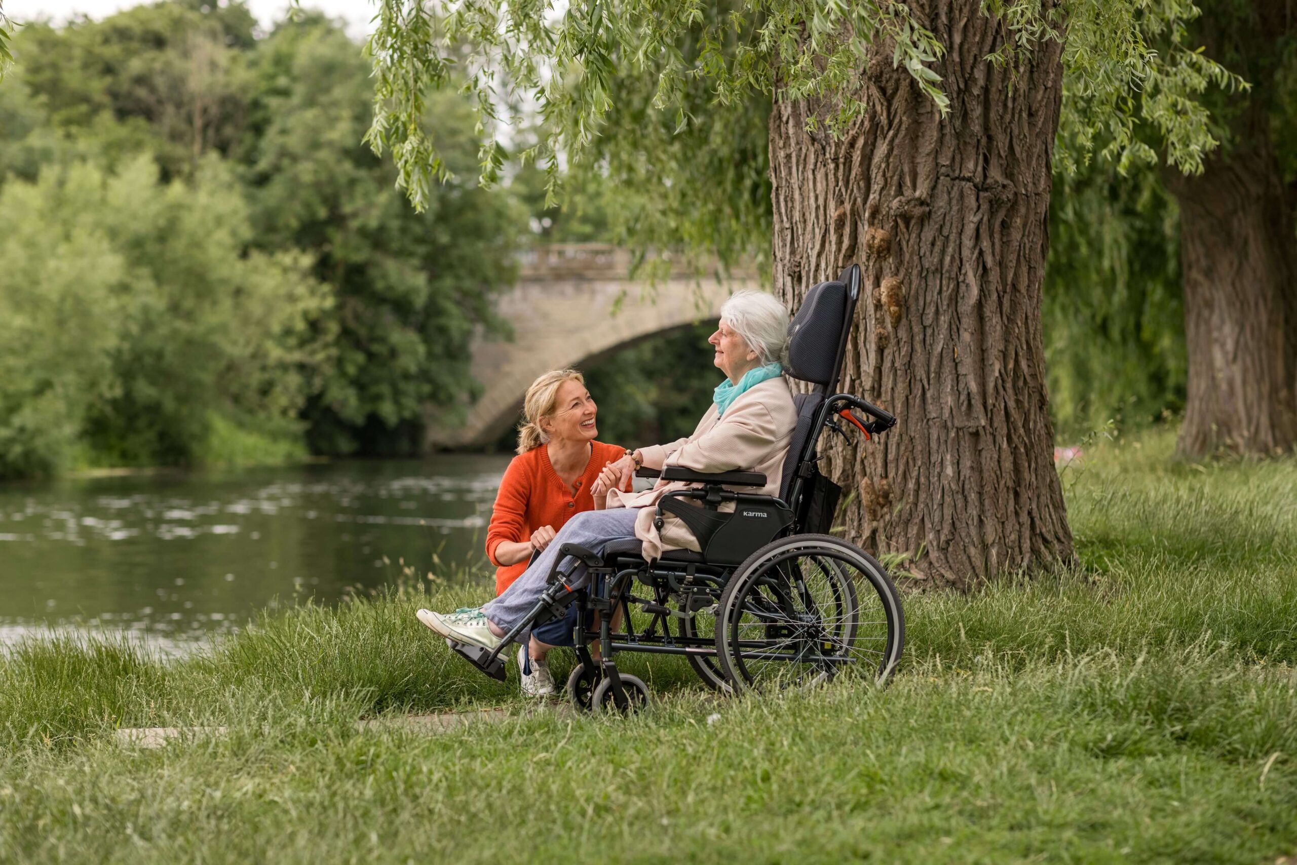 An-elderly-woman-in-a-positioning-wheelchair-chilling-with-her-daughter-by-the-river