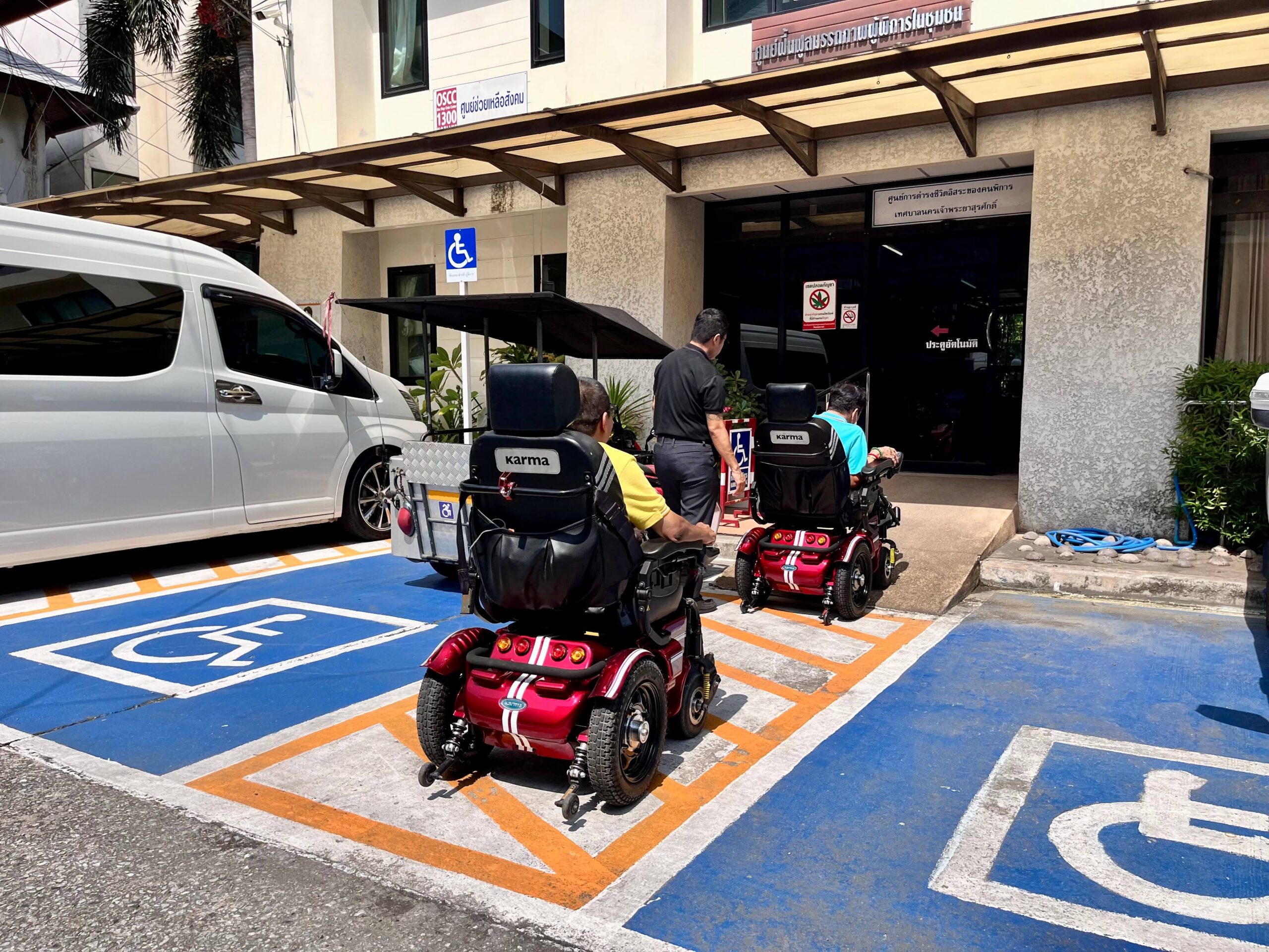 Two-power-wheelchair-users-entering-the-building