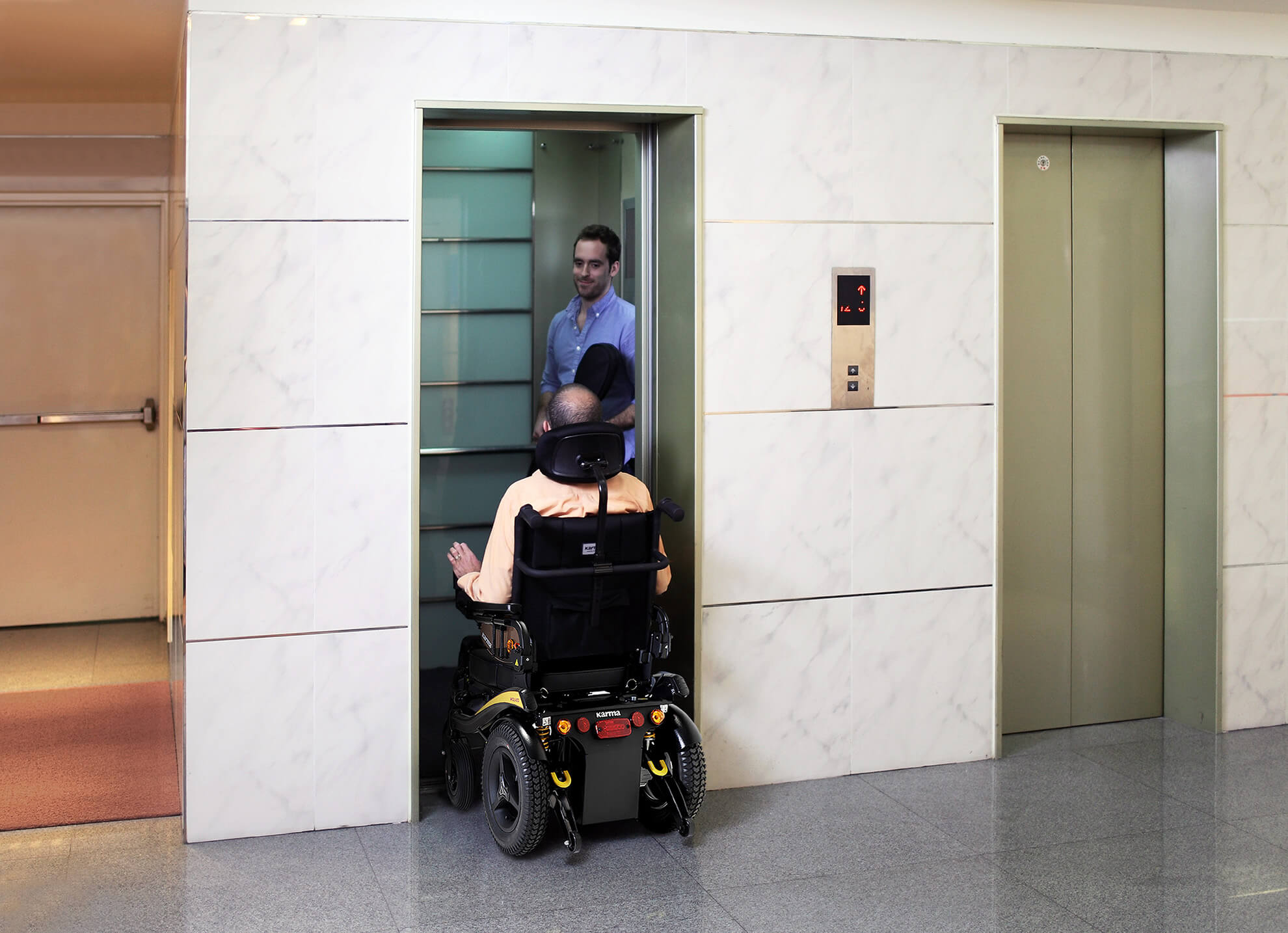 A-man-in-power-wheelchair-is-getting-into-the-elevator