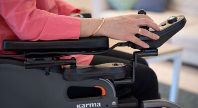 Woman-in-a-power-wheelchair-controlling-the-joystick