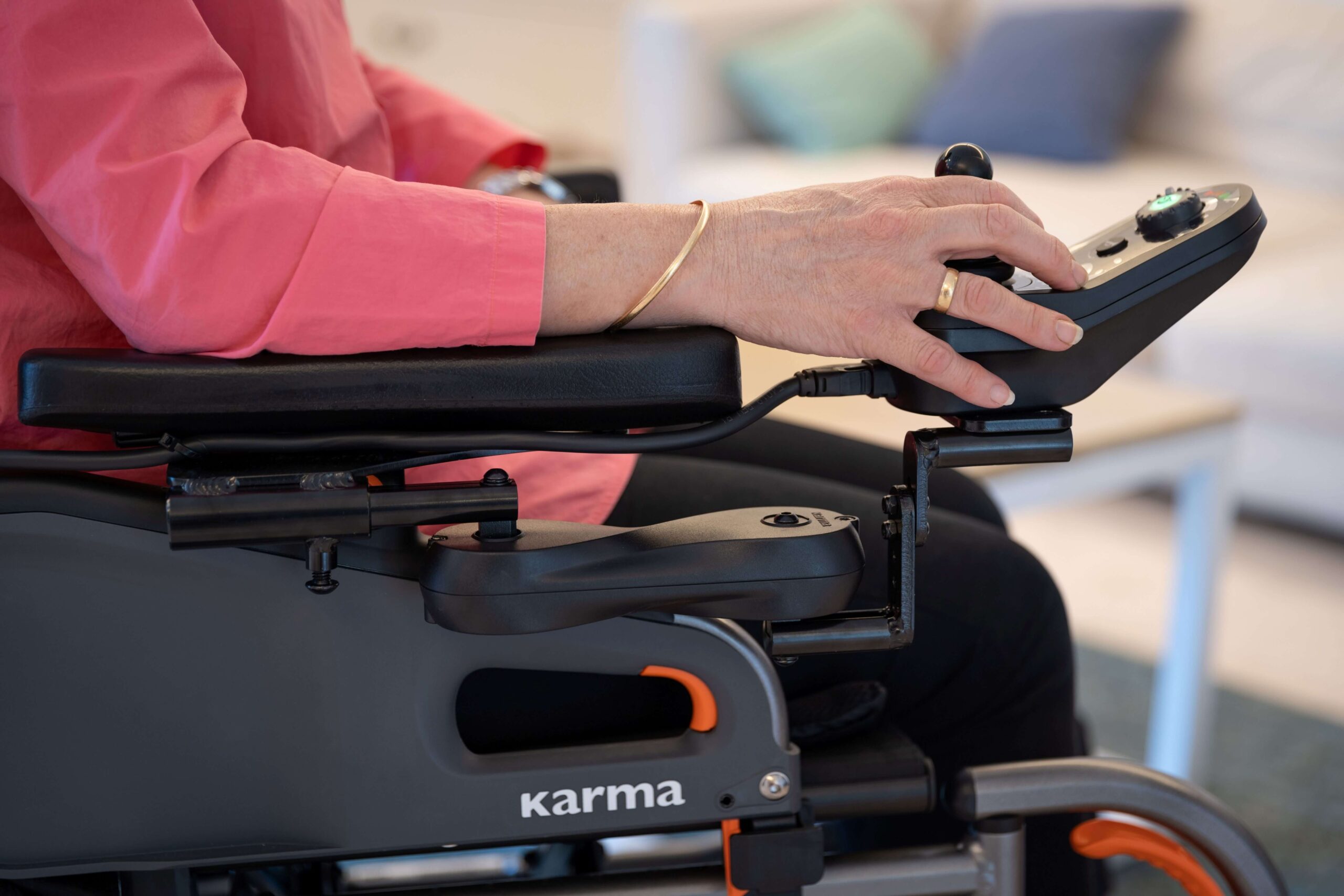 Woman-in-a-power-wheelchair-controlling-the-joystick