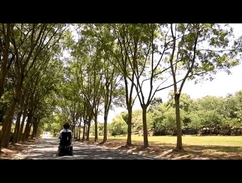 Man in power wheelchair driving away